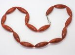 Коралл бусы овал выт-ый 10х30мм.ч/з узел*